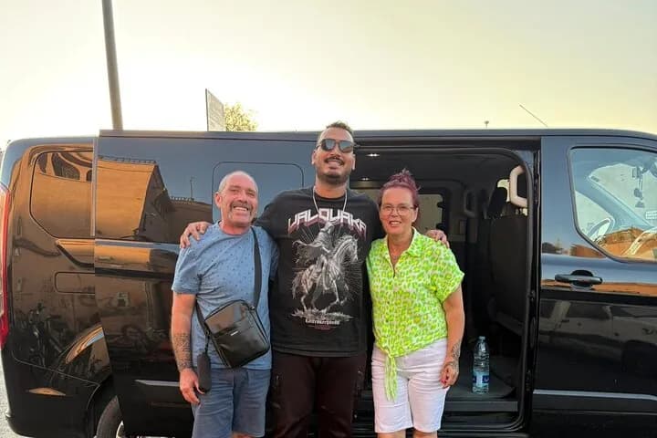 MTS Transfers driver with guests next to a private minivan